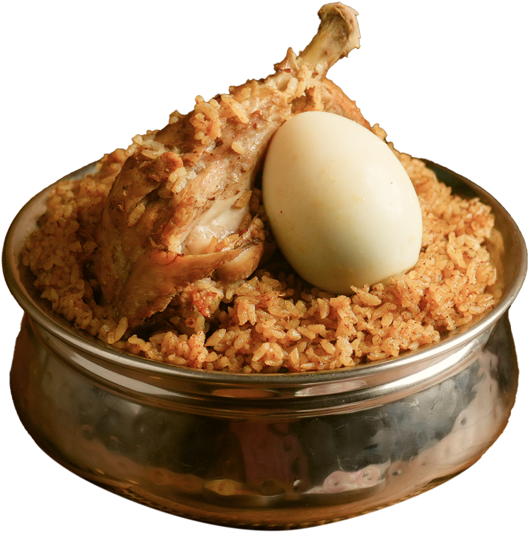 Chicken Biriyani in silver bowl with chicken leg and egg